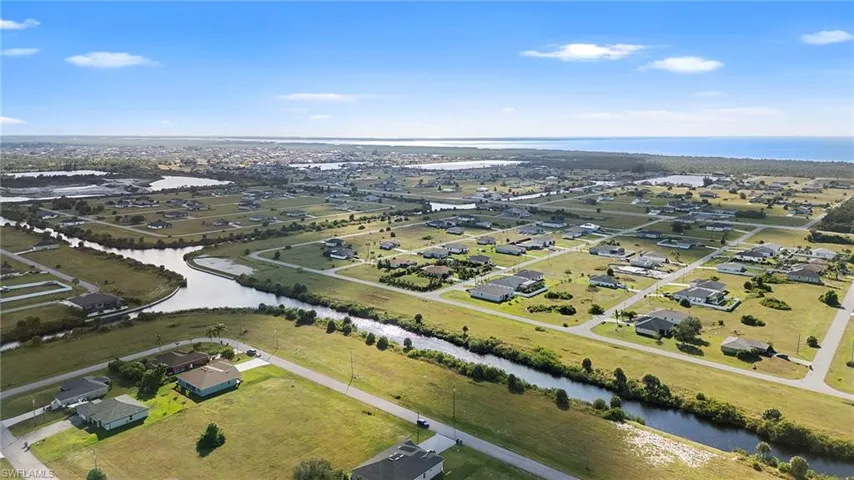 Aerial view of property's location featuring a nearby body of water