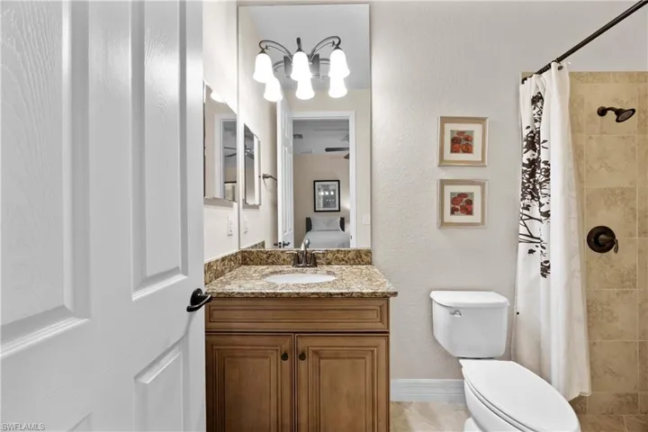 Bathroom with tile floors, vanity, and toilet