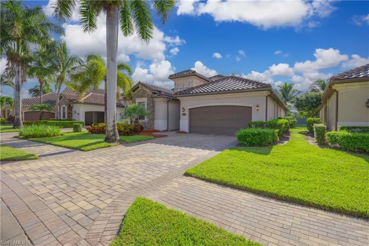 Mediterranean / spanish-style house with a garage and a front yard