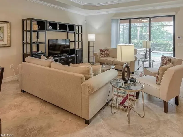 Living room featuring ornamental molding and light tile patterned floors