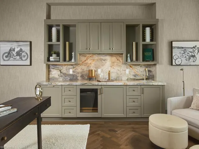 Kitchen featuring dark parquet flooring, gray cabinets, light stone counters, and sink