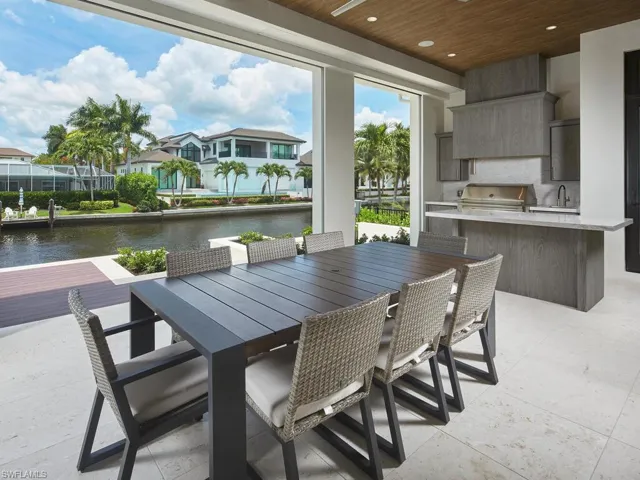 View of terrace featuring a water view, sink, a grill, and area for grilling