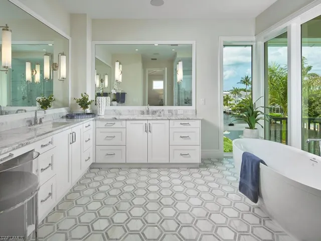 Bathroom with tile flooring, vanity, and a washtub