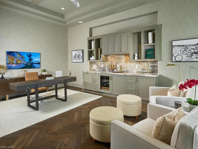 Living room with a tray ceiling, dark parquet floors, and beverage cooler