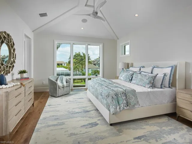 Bedroom featuring ceiling fan, vaulted ceiling, and hardwood / wood-style floors