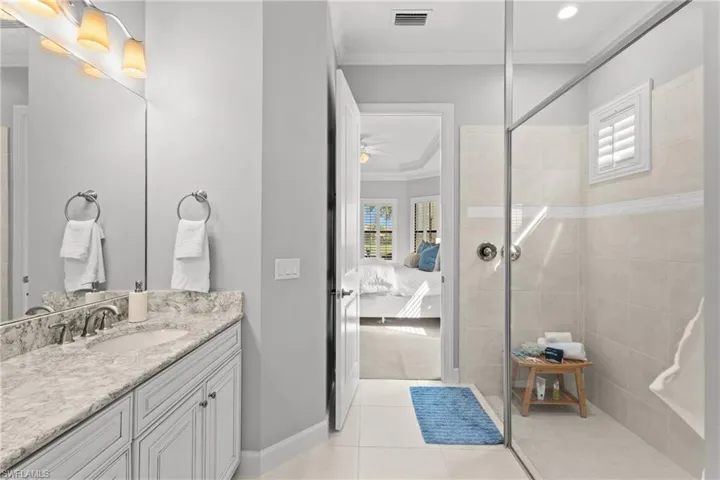 Vanity with a granite countertop, undermount sink, and brushed nickel faucet