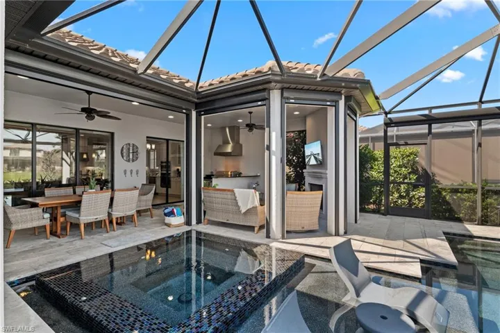 Full outdoor living complex with outdoor kitchen, dining, fireplace, spa and pool