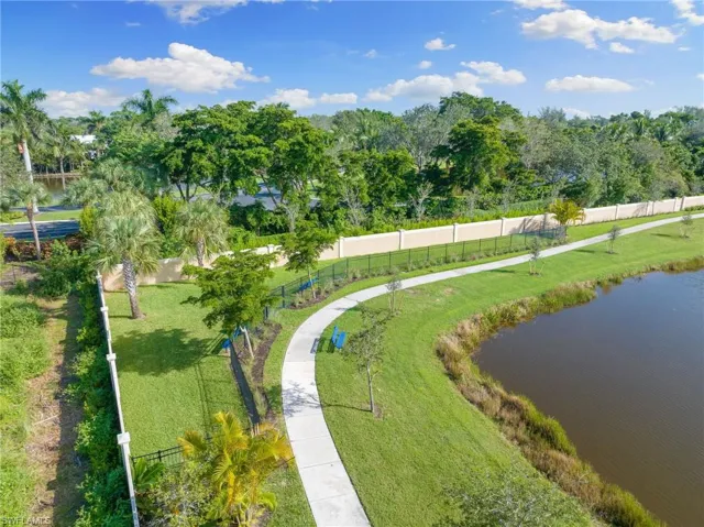 View of community with a water view and view of scattered trees