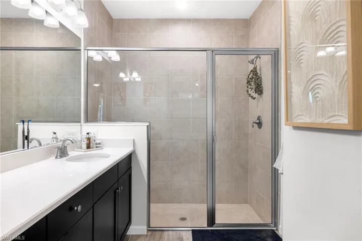 Bathroom with vanity and a shower stall
