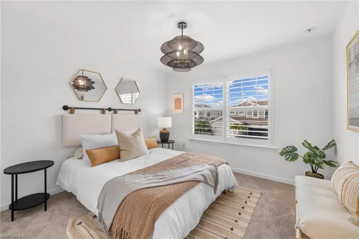 Bedroom featuring carpet and baseboards