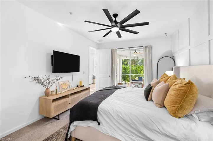 Carpeted bedroom with access to exterior and a ceiling fan
