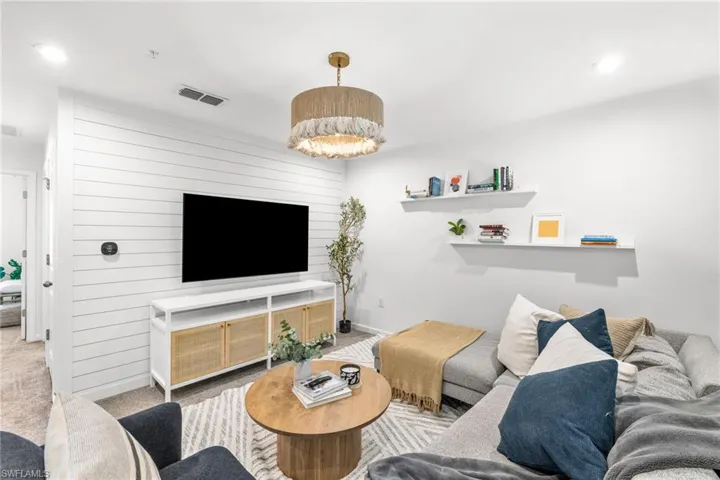 Carpeted living area featuring recessed lighting