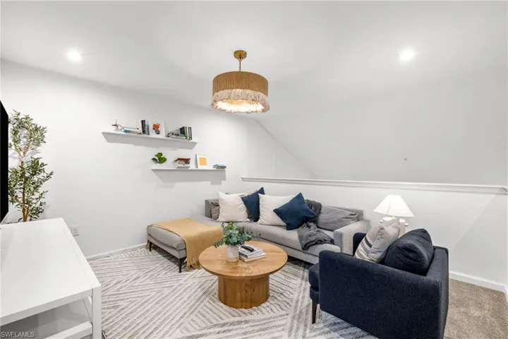 Living area featuring recessed lighting and vaulted ceiling