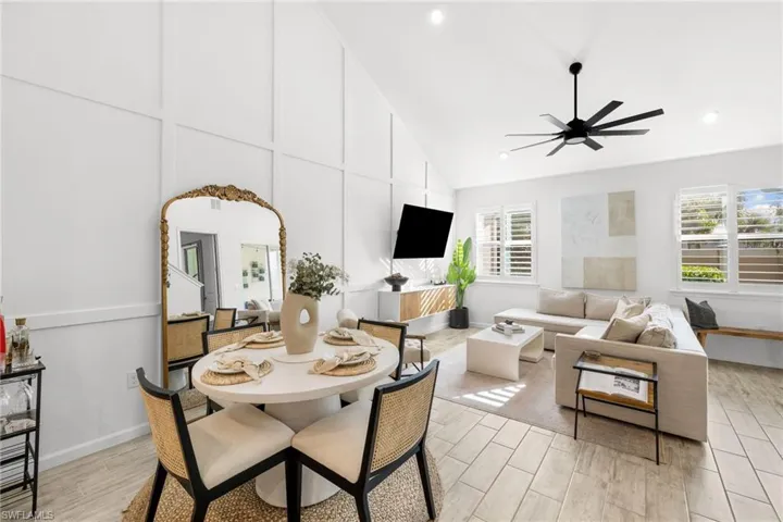 Dining area featuring wood tiled floors, lofted ceiling, and ceiling fan