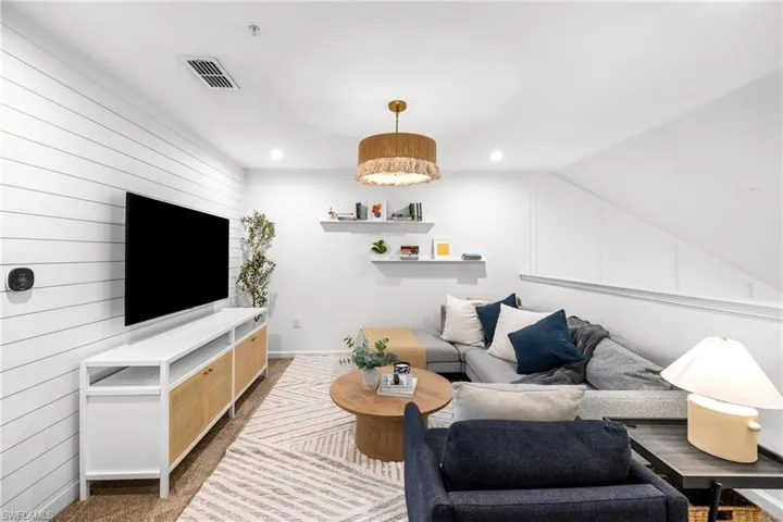 Living area with carpet flooring and recessed lighting