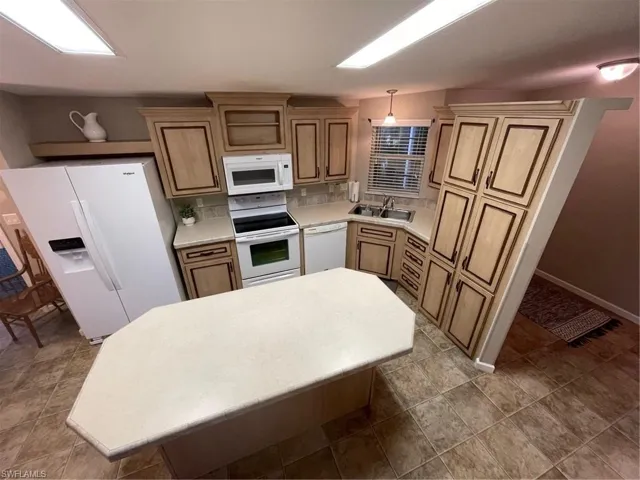 Kitchen with tile flooring, dishwasher, range, sink, and refrigerator