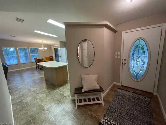Foyer featuring tile flooring and a chandelier
