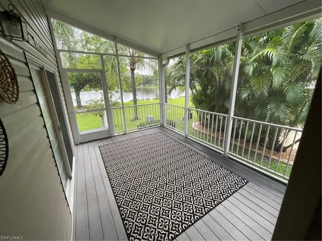 Sunroom / solarium featuring vaulted ceiling and a water view