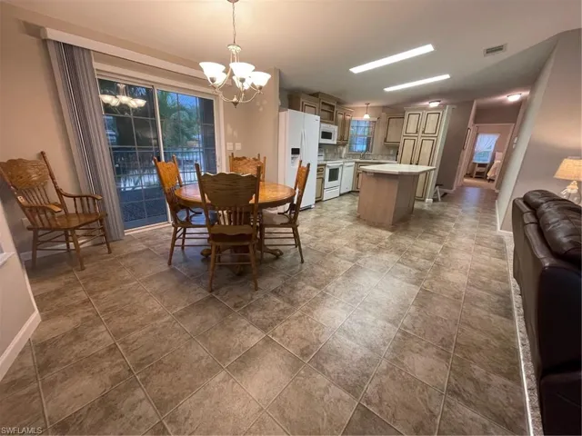 Dining area with tile floors and a chandelier