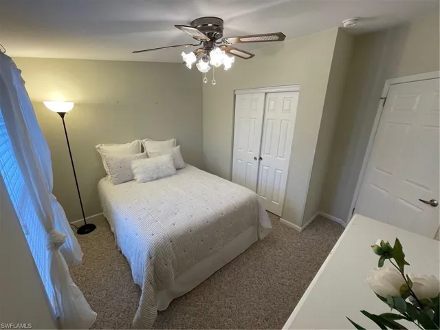 Carpeted bedroom with ceiling fan