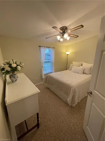 Bedroom featuring carpet and ceiling fan