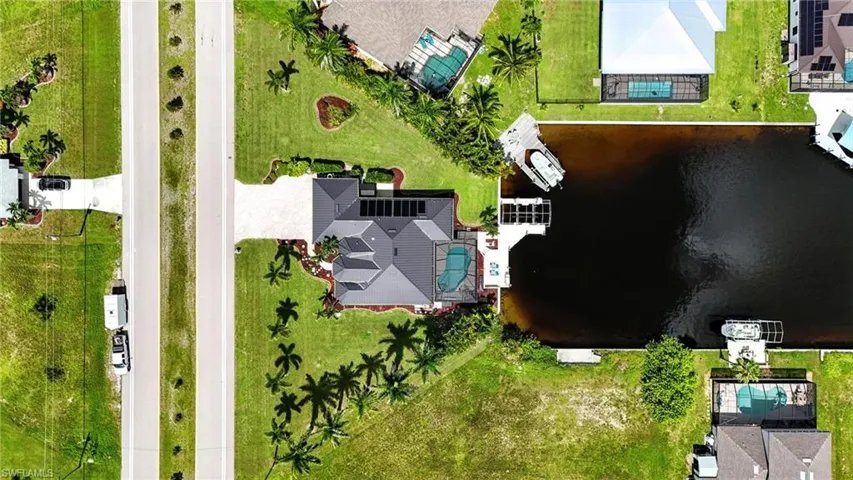 Aerial view of a pool area and a nearby body of water