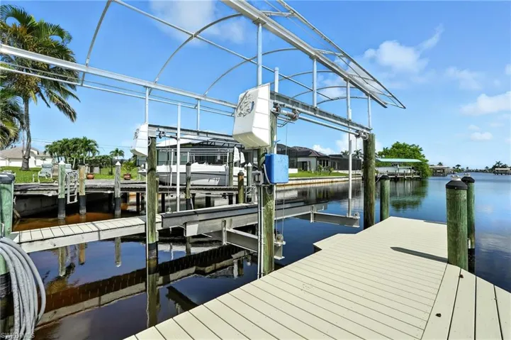 Dock with boat lift and a water view