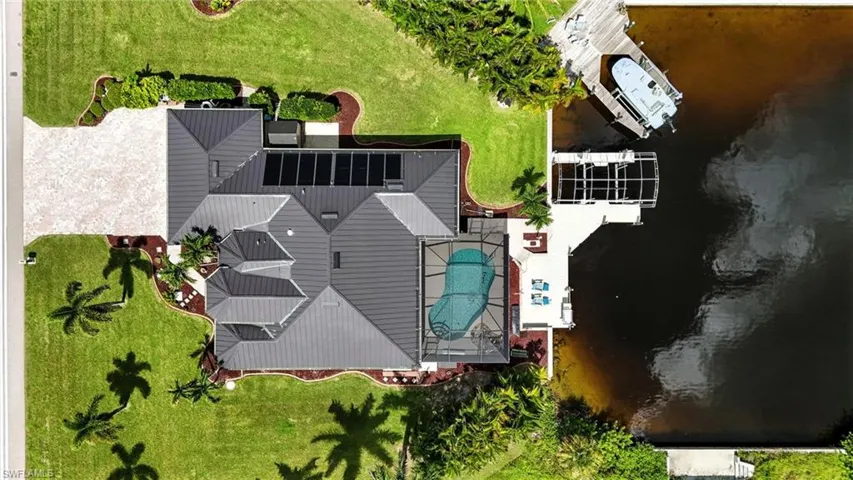 Aerial view of property and surrounding area featuring a pool