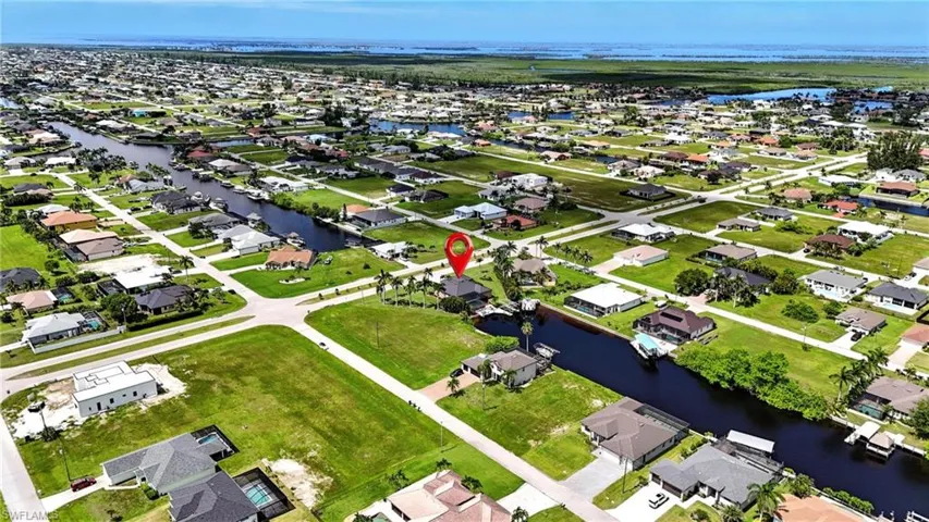 Aerial view of residential area featuring a nearby body of water