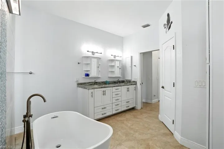 Bathroom with double vanity and a freestanding bath