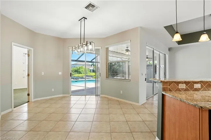 Unfurnished dining area featuring light tile patterned floors and a sunroom