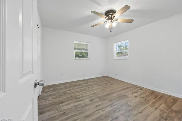 Unfurnished bedroom with wood finished floors and a ceiling fan