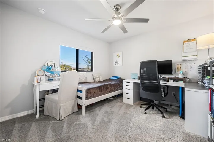 Bedroom with light carpet and ceiling fan