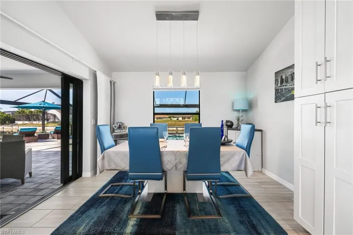 Dining space featuring light hardwood / wood-style floors and vaulted ceiling