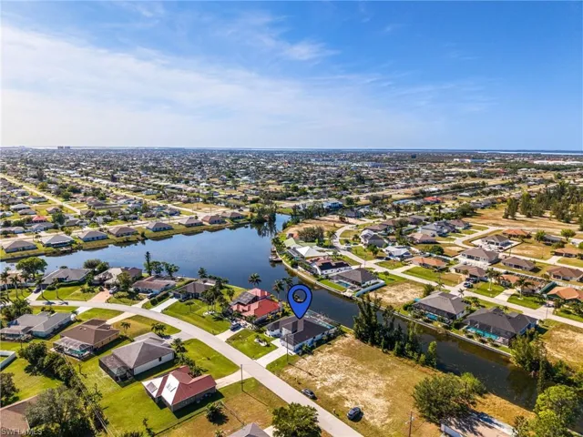 Birds eye view of property with a water view