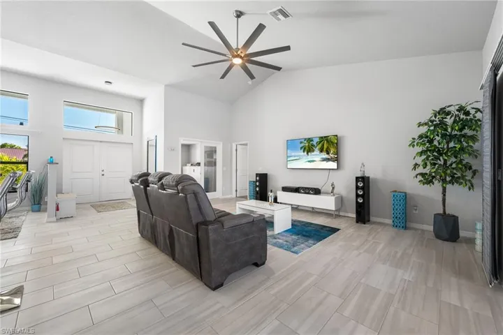 Living room with high vaulted ceiling and ceiling fan