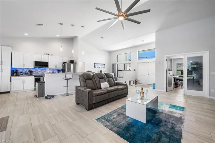 Living room with high vaulted ceiling and ceiling fan
