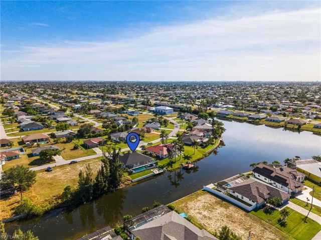Birds eye view of property with a water view