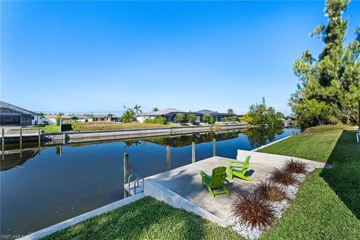 Dock area featuring a lawn and a water view