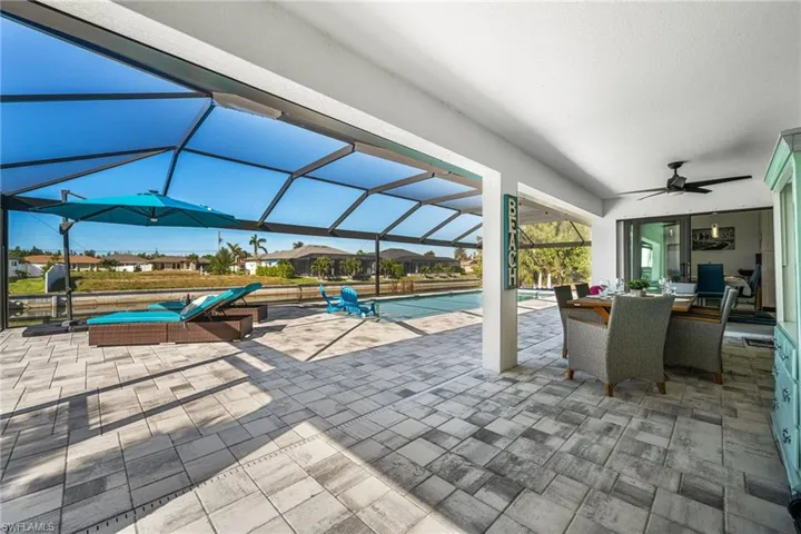 View of patio / terrace featuring ceiling fan and a lanai