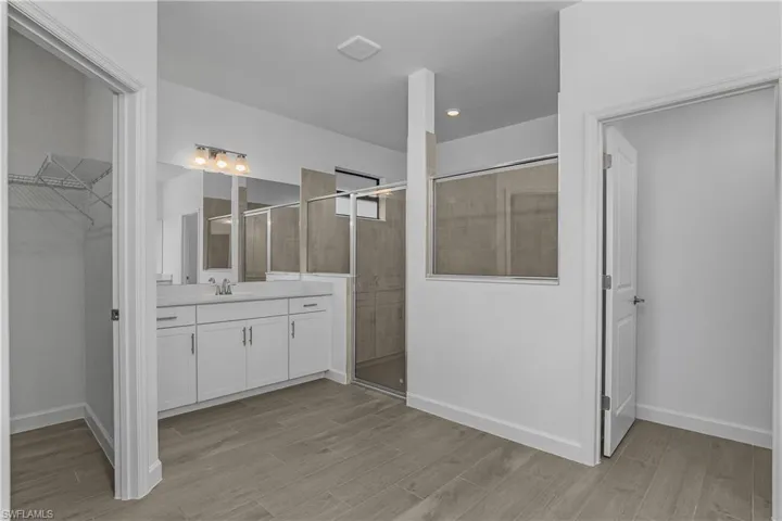 Owner bath with dual vanities, oversized walk-in shower, large his/hers closets, and private water closet.