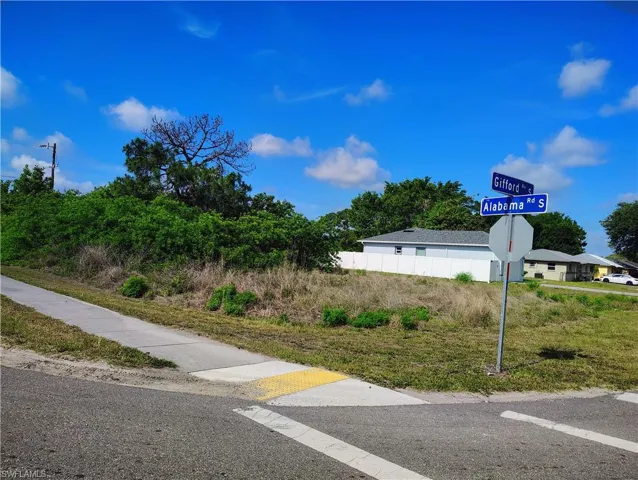 Corner lot featuring mature trees and street signage