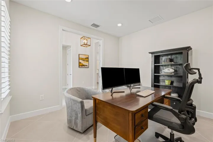 Home office with light tile patterned floors, recessed lighting, and plenty of natural light