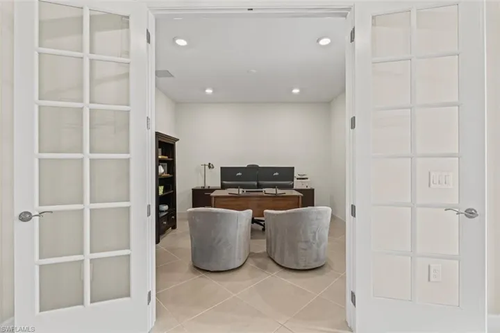 Office area featuring light tile patterned floors and recessed lighting