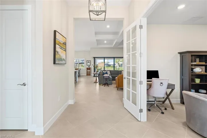 Office space with recessed lighting, light tile patterned floors, a chandelier, and french doors