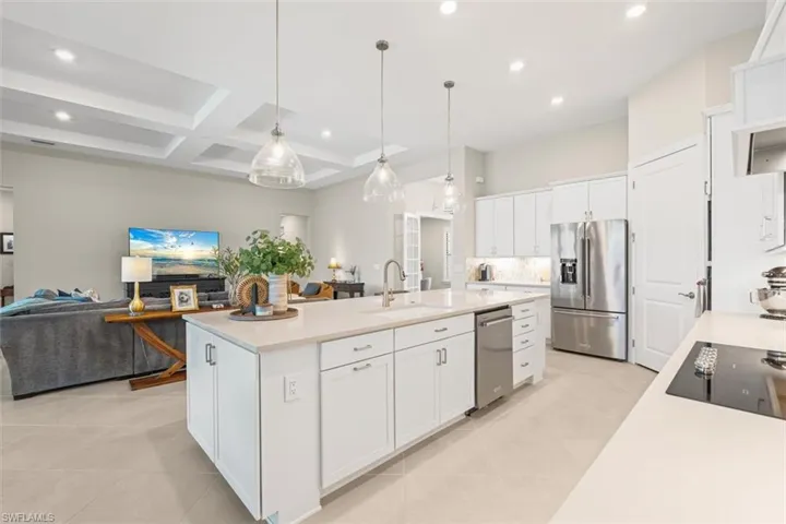 Kitchen featuring recessed lighting, coffered ceiling, beam ceiling, open floor plan, and light tile patterned flooring