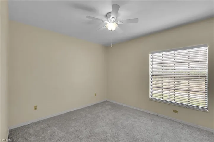 Unfurnished room with carpet floors and a ceiling fan
