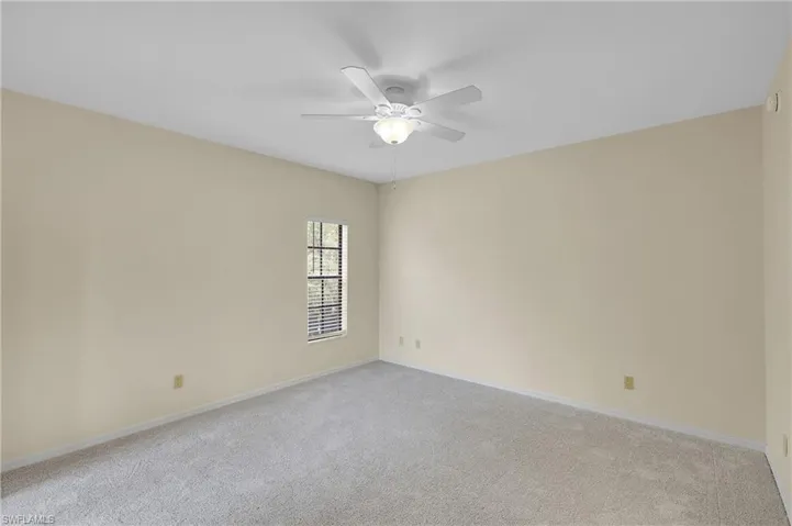 Spare room with light colored carpet and ceiling fan