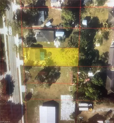 Aerial view of property and surrounding area featuring property boundaries highlighted