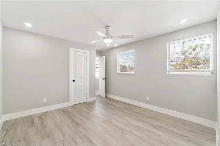 Spare room with ceiling fan, light wood-style floors, baseboards, and recessed lighting